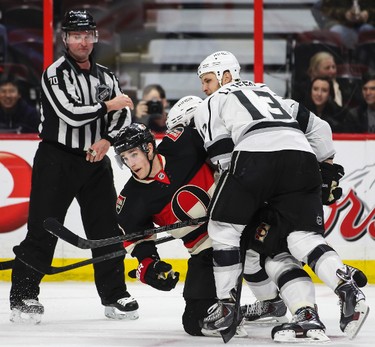Ottawa Senators' Kyle Turris is tied up by Los Angeles Kings' Kyle Clifford during NHL hockey action at the Canadian Tire Centre in Ottawa, Ontario on Thursday December 11, 2014. Errol McGihon/Ottawa Sun/QMI Agency