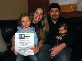 Krystal Walker, left, sits in her St. Thomas home with mother Angela, father Adam and three-month-old brother Andrew. Walker is holding a poster for an upcoming blood donor clinic in St. Thomas. (Ben Forrest, Times-Journal)