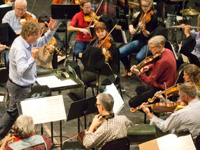 Members of Orchestra London rehearse at Centennial Hall in London on Tuesday. (CRAIG GLOVER, London Free Press)