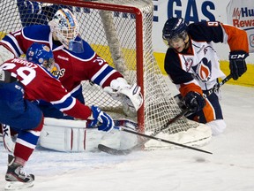 Kamloops Blazer Colin Smith attempts a wrap around on Edmonton’s Laurent Brossoit in a WHL match between the Blazers and the Oil Kings.