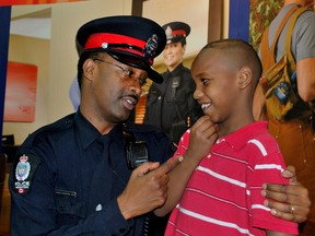 Edmonton Police Const. Achille Karuletwa speaks to a youth at an Africa Connect event in Edmonton Alta.  Karuletwa represents the Edmonton Police Service on the African Community Liaison Committee (ACLC). The Edmonton Police Chief's Community Advisory Council brings together Edmontonians of diverse cultural or social backgrounds to help guide the police service in its delivery of services to the community. The ACLC serves as a sub-committee to the Council. Photo Supplied/EPS