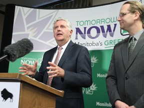 Conservation Minister Gord Mackintosh (left) and Wolseley MLA Rob Altemeyer talk about a discussion paper on recycling and waste reduction during a press conference at the Manitoba Legislative Building in Winnipeg, Man., on Fri., Dec. 12, 2014.