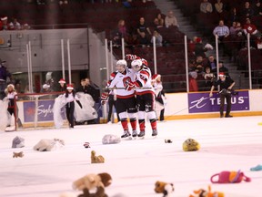 Ottawa 67's winger Kevin Groulx celebrates his first-ever OHL goal with Brendan Bell during the first period of Friday night's game against Belleville. The powerplay goal triggered a barrage of stuffed animals thrown onto the ice as part of the team's annual Teddy Bear Toss. The collected stuffed animals are donated to children in need for Christmas. (Chris Hofley/Ottawa Sun