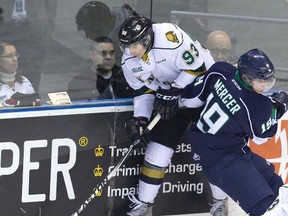 Knights forward Mitch Marner makes a cross-ice pass despite being knocked into the air by Plymouth Whalers? Cullen Mercer during the first period of their OHL game at Budweiser Gardens on Friday night. Marner?s London teammate Christian Dvorak accepted the pass and shot the puck past Whalers goalie Alex Nedelijkovic for a 1-0 lead. (DEREK RUTTAN, The London Free Press)