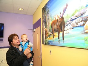 JOHN LAPPA/THE SUDBURY STAR
David Kruk and his son, Joziah, 10 months, check out the play room area at the remodelled pediatric oncology unit at the Northeast Cancer Centre in Sudbury on Friday, Dec. 12. The makeover was made possible by the Smilezone Foundation.