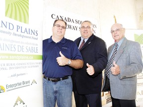 Paul Corriveau, left, president of the North America Railway Hall of Fame, joins Conservative MP Joe Preston and John Wilson, Malahide mayor and member of the Sand Plains Community Development Fund committee, for announcement in 2010 of $250,000 in federal funding to restore the historic Canada Southern Railway station.