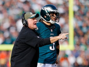 Quarterback Mark Sanchez of the Philadelphia Eagles stands alongside head coach Chip Kelly in the first half of the game against the Tennessee Titans at Lincoln Financial Field on November 23, 2014. (Rich Schultz/Getty Images/AFP)