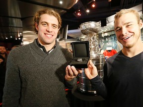 Los Angeles Kings players Anze Kopitar and captain Dustin Brown present a Stanley Cup ring at a ceremony where the Kings were donating it to the Hockey Hall of Fame's collection in Toronto on  Dec. 13, 2014. (Michael Peake/Toronto Sun)