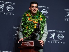Oregon Ducks quarterback Marcus Mariota poses with the Heisman Trophy during a press conference at the New York Marriott Marquis after winning the Heisman Trophy on Dec 13, 2014 in New York, NY, USA. (Brad Penner/USA TODAY Sports)