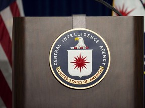 The lectern stands empty as reporters await the arrival of Director of Central Intelligence Agency John Brennan for a press conference at CIA headquarters in McLean, Virginia, December 11, 2014. AFP PHOTO/JIM WATSON