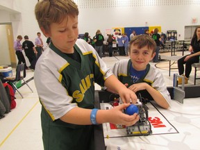 James Daamen, 11, and Evan Burke, 9, with the St. Joseph Saints, try out one of the rehearsal courses at Saturday's Sarnia Regional FIRST LEGO League Robotics Tournament held at Rosedale Public School. A total of 11 teams took part.