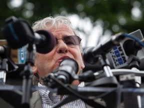 Gilles Rousseau, father of teacher and shooting victim Lauren Rousseau, speaks to residents gathered outside the town hall in Newtown during the six month anniversary of the massacre at Sandy Hook Elementary in Newtown, Connecticut June 14, 2013. Six months after a gunman killed 26 children and adults at a Newtown, Connecticut, elementary school, families and local officials will mark the day by honoring the victims and renewing the fight for stricter gun control.  REUTERS/Michelle McLoughlin