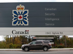 A vehicle passes a sign outside the Canadian Security Intelligence Service (CSIS) headquarters in Ottawa November 5, 2014. REUTERS/Chris Wattie