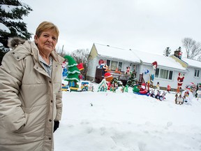 Debbie Archambault in front of her Palsen Street home. Her late husband, J.P. Archambault loved collecting Christmas decorations so much that not all of the figurines can be displayed at once. 
(DANI-ELLE DUBE/OTTAWA SUN)