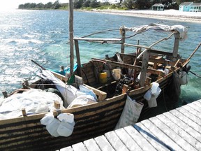 A wooden boat that had been used by Cuban rafters is moored at a dock in George Town December 14, 2014. A group of 26 Cubans on a homemade wooden boat were granted temporary refuge in the Cayman Islands when bad weather interrupted their quest to seek exile in the United States.The four women and 22 men, almost all from the coastal town of Santa Cruz Del Sur in the southeastern province of Camaguey, were four days into their journey when they took shelter from high seas on Wednesday. Cayman authorities said on Saturday that they could remain until the weather improves. REUTERS/Peter Polack