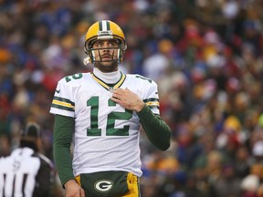 Aaron Rodgers #12 of the Green Bay Packers looks at the clock against the Buffalo Bills during the second half at Ralph Wilson Stadium on December 14, 2014 in Orchard Park, New York.  (Tom Szczerbowski/Getty Images/AFP)
