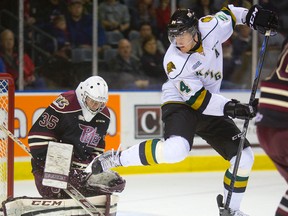 Knights forward Michael McCarron jumps out of the way of a low shot that Peterborough Petes goalie Scott Smith stops with a pad during the first period at Budweiser Gardens on Sunday.  (MIKE HENSEN, The London Free Press)