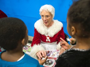 Mrs. Claus handed out some magical reindeer dust to kids as she took them through the Claus' family album at the Children's Christmas party at the Michele Heights Community Centre Sunday, Dec. 14, 2014.
DANI-ELLE DUBE/Ottawa Sun/QMI Agency