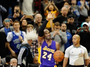 Kobe Bryant #24 of the Los Angeles Lakers waves to the crowd after passing Michael Jordan on the all-time scoring list with a free throw in the second quarter of the game on December 14, 2014 at Target Center in Minneapolis, Minnesota. (AFP)