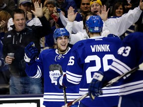 Maple Leafs forward Mike Santorelli (left) celebrates with teammate Daniel Winnik after scoring against the L.A. Kings on Dec. 14, 2014 at the Air Canada Centre. Both players joined the Leafs in the off-season. (CRAIG ROBERTSON/Toronto Sun)
