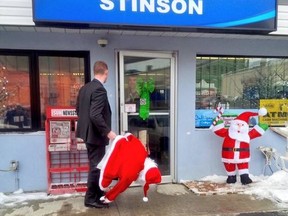 Kingston Police Det. Cam Gough returns the stolen Santa to the Stinson gas station this weekend. The owner, Romeo Dipchand, declined to press charges and the suspect received a warning.  (Kingston Police/QMI Agency)