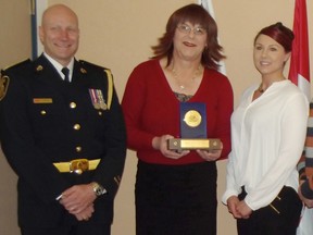 Jim Moodie/The Sudbury Star   
Greater Sudbury Police Chief Paul Pedersen, left, Rita OLink of TG Innerselves, and Special Const. Andrea Benoit celebrate an award from the International Association of Police Chiefs at a police board meeting on Thursday. Also present to share in the accolade were Supt. Sheilah Weber, Anna Barsanti of the Community Mobilization Unit, communications officer Kevin Deforge, and Darlyn Hansen and Vincent Bolt of TG Innerselves.