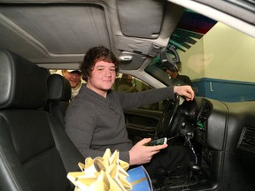 JOHN LAPPA/THE SUDBURY STAR
Local teenager Denis Faubert checks over his car following a car reveal at Fix Auto in Chelmsford on Saturday. The vehicle was fixed up thanks to Make-A-Wish Eastern Ontario and a number of businesses that donated their time, expertise and parts to makeover the 1996 BMW. The businesses include Fix Auto, Witrak Auto, NAPA Auto Parts, Bianco's Supercenter, Johnny's Towing, Vision Auto Glass, G Tech Auto Glass, R.L. Upholstery and Yves Tourigny. Denis, who suffers from an autoimmune disorder, hadn't seen his car since September. The reveal was made on his 18th birthday.