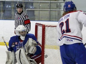 Kingston Voyageurs' Cole Bolton scores on Oakville Blades goaltender Daniel Mannella to tie the game at 1-1 during the first period of Ontario Junior Hockey League action at the Invista Centre on Sunday.  The Voyageurs won 5-1 over the visiting Blades. (Julia McKay/The Whig-Standard)