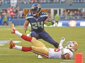 Seahawks running back Marshawn Lynch tries to get around a fallen 49ers defender on Sunday in Seattle. (USA TODAY SPORTS)