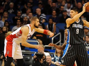 Orlando Magic centre Nikola Vucevic (right) works against Toronto Raptors centre Jonas Valanciunas at Amway Center in Orlando on Nov. 1, 2014. (DAVID MANNING/USA TODAY Sports)