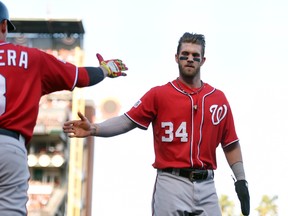 Washington Nationals left fielder Bryce Harper (34) celebrates with second baseman Asdrubal Cabrera (3) after scoring a run during the seventh inning against the San Francisco Giants in game three of the 2014 NLDS baseball playoff game at AT&T Park. (Kyle Terada-USA TODAY Sports)