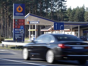 A car passes by a Statoil gas station in Norway. The nation has an enormous oil heritage fund worth well over a trillion dollars but is facing various challenges in what to do with that wealth. (REUTERS/Ints Kalnins)