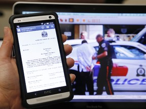 A copy of the decision made by the Supreme Court of Canada late last week allowing warrantless police searches of cellphones in possession of suspects is seen on a cellphone. - PHOTO ILLUSTRATION BY JEROME LESSARD/THE INTELLIGENCER/QMI AGENCY