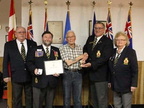 Royal Canadian Legion Branch # 269 member and Second World War veteran Alf Armstrong, centre, received his 70-year membership bar for seven decades of continuous membership in the Royal Canadian Legion.