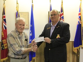 Drayton Valley and District Historical Society President Charlie Miner accepts a donation from Royal Canadian Legion Branch #269 President Bill Cavanagh.