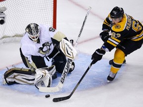 Pittsburgh Penguins goalie Tomas Vokoun (left) makes a save on Boston Bruins forward Brad Marchand during Game 4 of the NHL Eastern Conference final in Boston, June 7, 2013. (REUTERS/Brian Snyder)