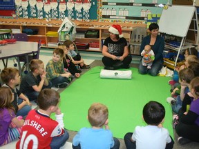 Grade 1 class at Evergreen Elementary students sit around the carpet to watch and learn about empathy from baby Taryn.