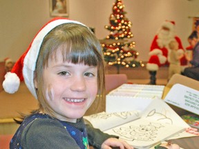 Allison Bleck takes a break from colouring a Christmas picture to smile for the camera during the Dublin Lions Club Family ‘Breakfast with Santa’ event, held on Saturday, Dec. 6 at the Dublin Lions Pavilion. KRISTINE JEAN/MITCHELL ADVOCATE