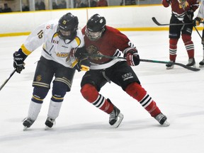 Adam Zehr (22) of the Mitchell Hawks collides with Wingham Ironman Matt McCracken (15) during Western Jr. C hockey league action Saturday, Dec. 13 in Mitchell. The Hawks lost another heartbreaker, 4-3 in overtime. ANDY BADER/MITCHELL ADVOCATE