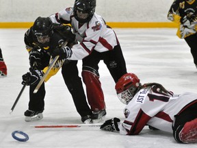 Emily Anstett (left) of the Mitchell U14AA ringette team zeroes in on the loose ring during CORL regular season action against Oshawa last Saturday, a 5-4 loss. ANDY BADER/MITCHELL ADVOCATE