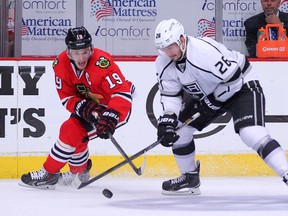 Chicago Blackhawks centre Jonathan Toews (19) steals the puck from Los Angeles Kings defenceman Slava Voynov during Game 7 of the 2014 Western Conference final at the United Center. (Dennis Wierzbicki/USA TODAY Sports)
