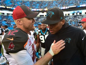 Tampa Bay Buccaneers quarterback Josh McCown (12) with Carolina Panthers quarterback Cam Newton (1) after the game. The Panthers defeated the Buccaneers 19-17 at Bank of America Stadium on Dec 14, 2014 in Charlotte, NC, USA. (Bob Donnan/USA TODAY Sports)