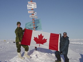 All the way to the North Pole, on the top of the world Bdr. Yannick Tessier and Sgt. Claude Gelinas proudly display Canadian Flag.