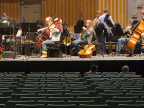 Members of Orchestra London prepare to rehearse at Centennial Hall in London. (Free Press file photo)