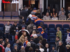 Edmonton fans leave with 21 seconds remaining on the clock during the third period of a NHL hockey game between the Edmonton Oilers and New York Rangers at Rexall Place in Edmonton, Alta., on Sunday, Dec. 14, 2014. Ian Kucerak/Edmonton Sun