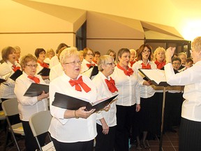 Members of the G-Clef Choir sing Christmas songs at the Lake of the Woods Museum’s open house on Monday, Dec. 15.