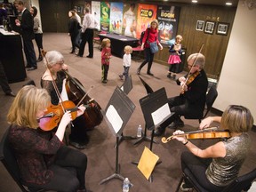 Several members of Orchestra London, including this string quartet, filled the halls of the Grand Theatre with music during the Richmond St. theatre?s Pop-Up Holiday Party in London on Monday. (DEREK RUTTAN, The London Free Press)
