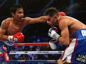 Manny Pacquiao (left) punches Chris Algieri during their WBO welterweight title fight in Macau on Nov. 23, 2014. (Tyrone Siu/Reuters)
