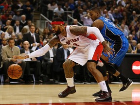Raptors' James Johnson (3) reaches for the ball as Orlado Magic's Maurice Harkness  guards him on Dec. 15. (Jack Boland, Toronto Sun)