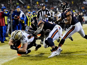 Saints tight end Josh Hill (left) scores a touchdown against Bears inside linebacker Christian Jones (59), cornerback Tim Jennings (26) and free safety Brock Vereen (45) during first half NFL action in Chicago on Monday, Dec. 15, 2014. (Matt Marton/USA TODAY Sports)